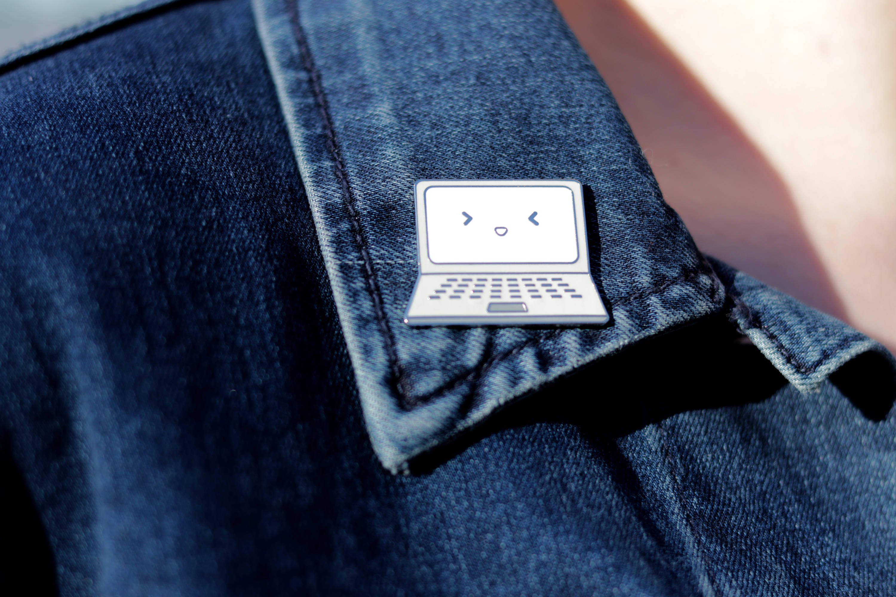 Gray Laptop Hard Enamel Pin Pinned to Blue Jean Jacket