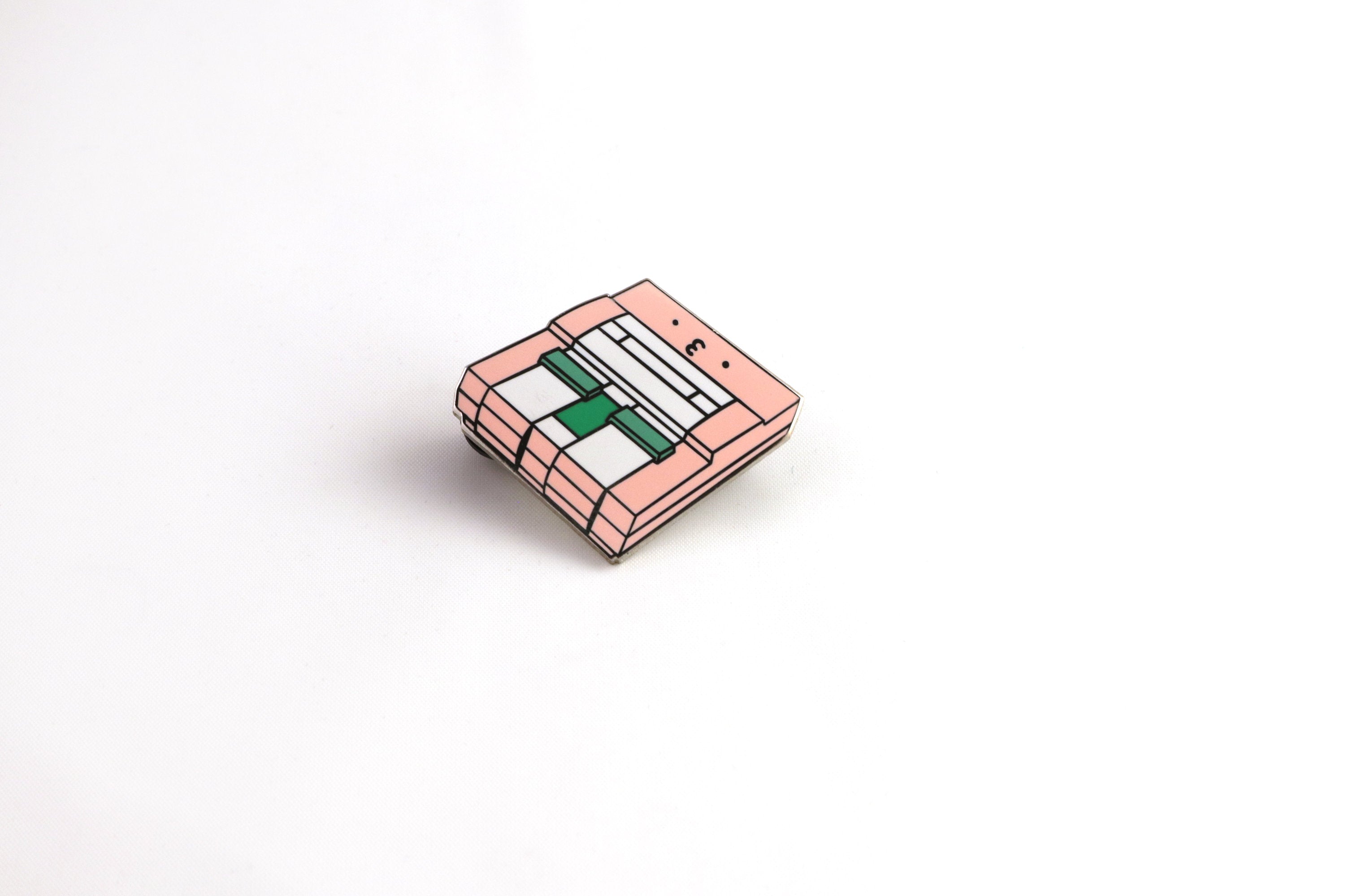 Pink SNES Console Hard Enamel Pin on White Background