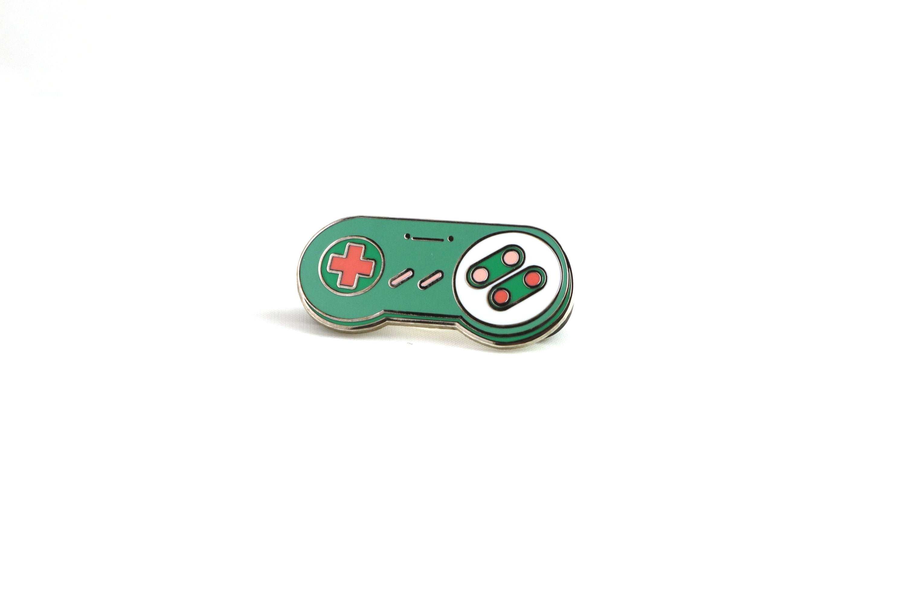 Green and Pink SNES Controller Hard Enamel Pin on White Background