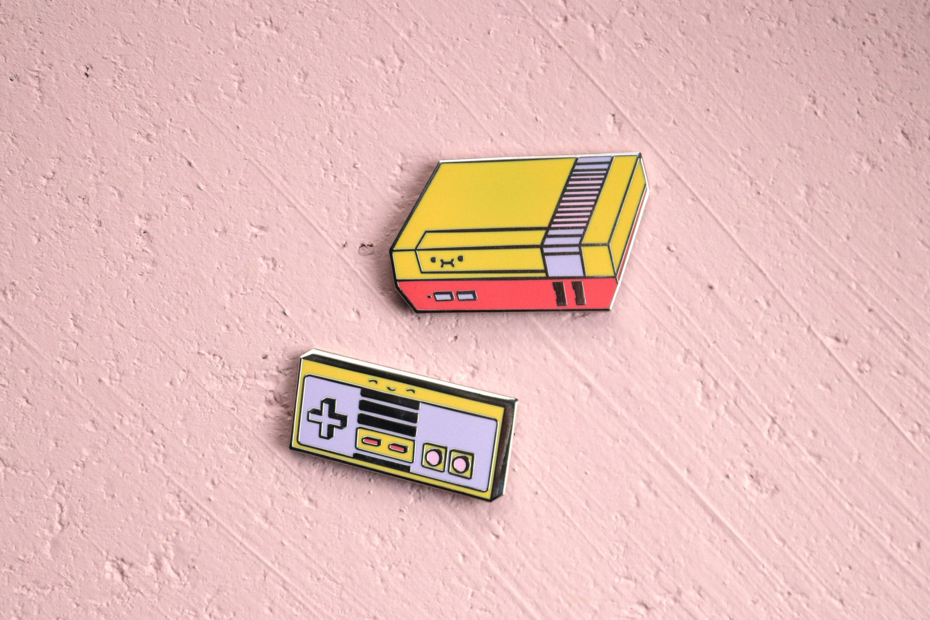 Custom NES Console and Controller Pins on Pink Cork Board Background