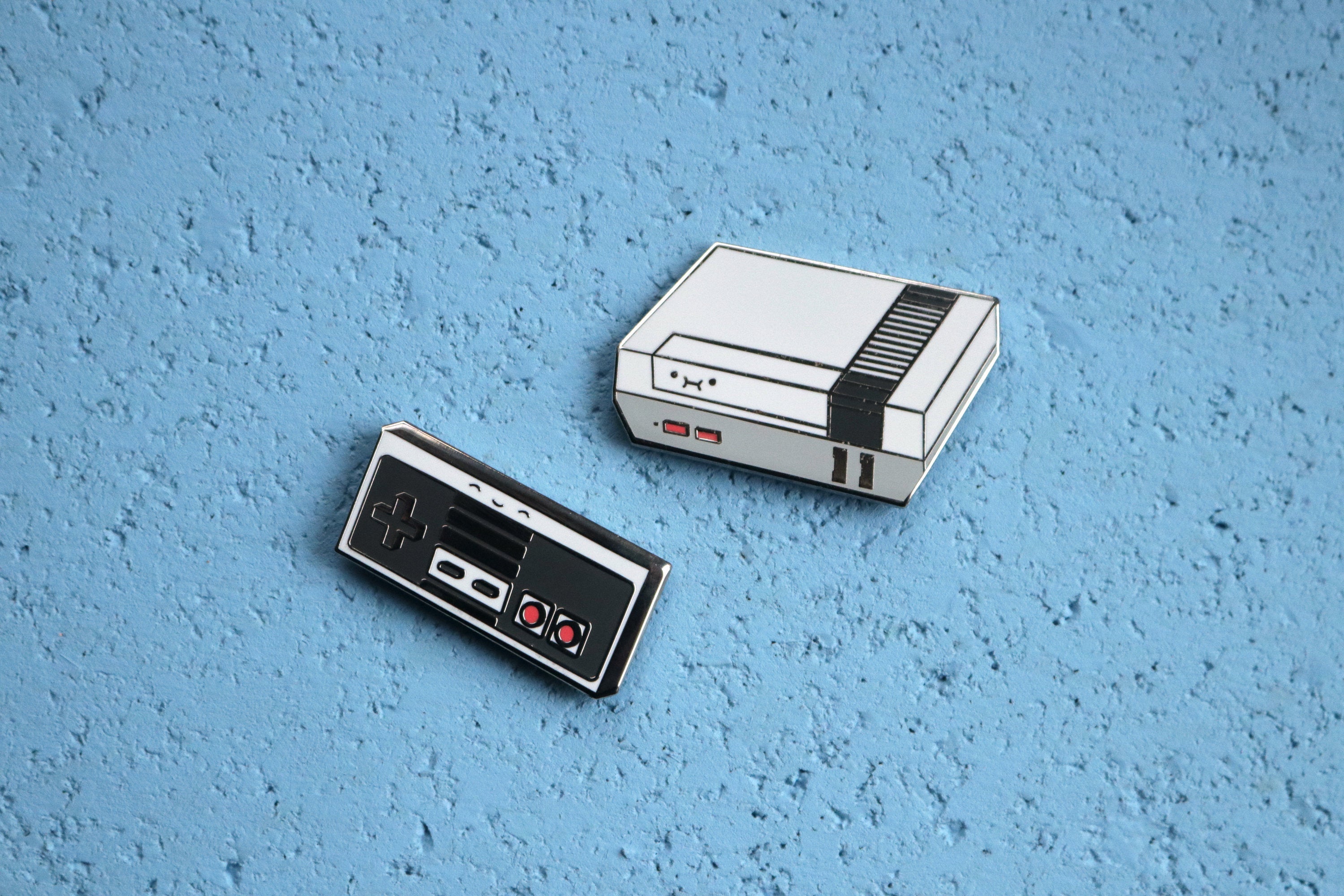 Gray NES Console and Controller on Blue Cork Background