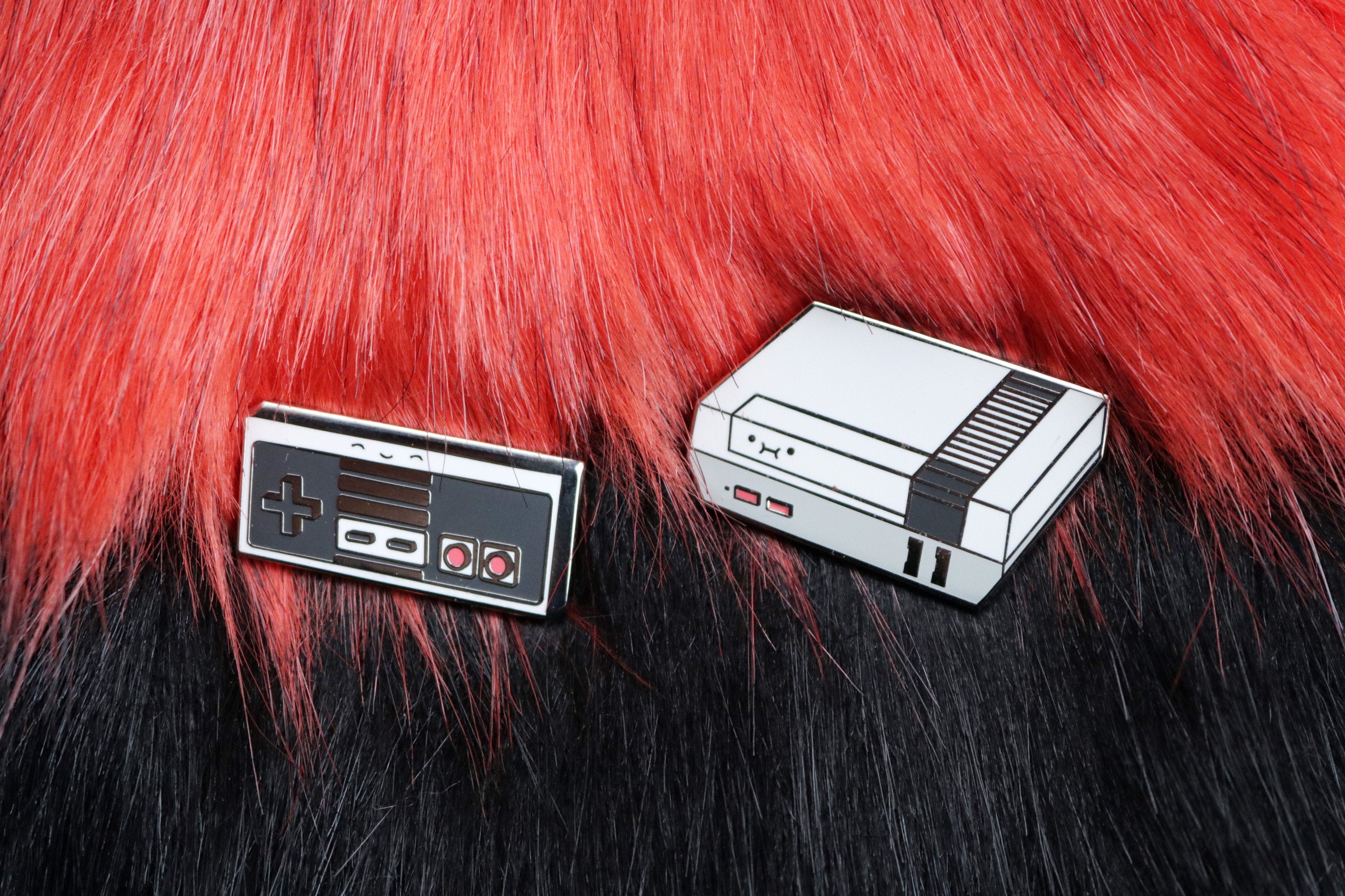 Gray NES Console and Controller on Red and Black Fur Background