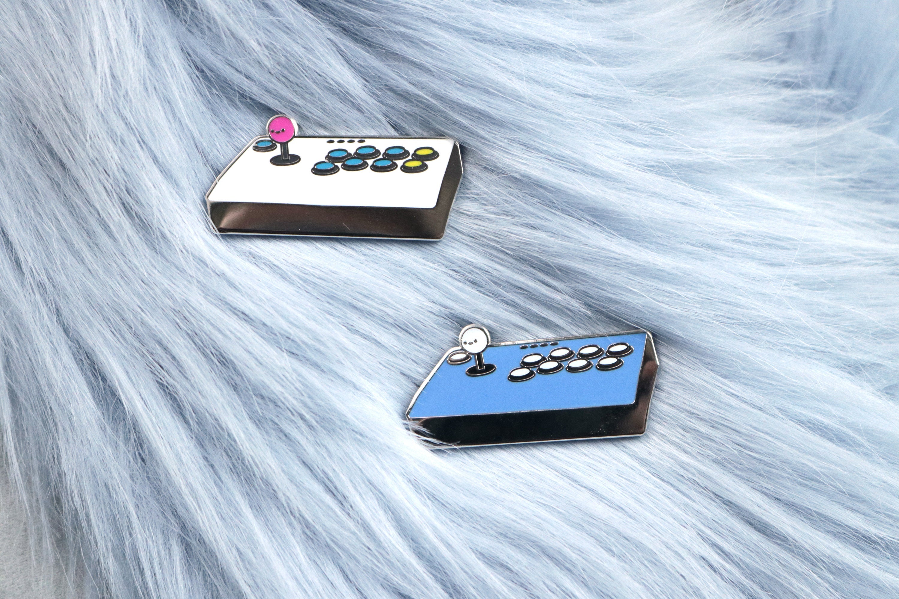 White and Blue Fight Stick Hard Enamel Pins on Blue Fur